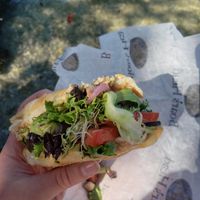 a sub style bread with homemade hummus, mixed green, cucumber, tomato, bean sprouts, and sweet pickled onion at Michelle's Brown Bag Cafe in Sarasota