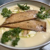 Cream white vegetable soup with smoked tofu  at Owca Cała in Poznan