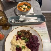 Pumpkin & tomato cream soup and gnocchi with “Goose” (jackfruit)  at Owca Cała in Poznan