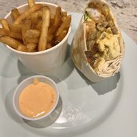 Half of the burrito and fries   at The Impossible Shop in Austin