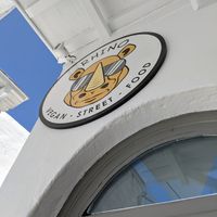 Easy to spot streetside sign at Rhino Vegan Beat in Mykonos