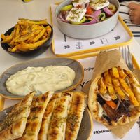 gyros wrap, tsaziki, fries, greek salad at Rhino Vegan Beat in Mykonos
