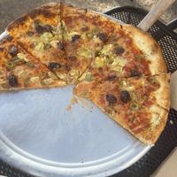 Vegan pizza with olives and artichoke hearts and vegan cheese. Kids were hungry and grabbed slices before I could take a picture.   at Escalante Outfitters in Escalante