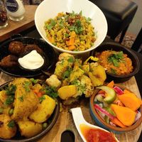 Indian style main for 2 persons. On the left meat balls for the non-vegan, on the right a bland Dahl (to share) as the vegan alternative. Having a special vegan snack (maybe samosa at FoodVia in Arnhem