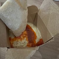 Houmous and pitta bread with a spicy sauce at Nando's in Borehamwood