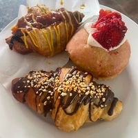 Sausage sizzle croissant, Strawberry lemonade filled donut, Snickers croissant at Belén Vegan Bakery in Wellington