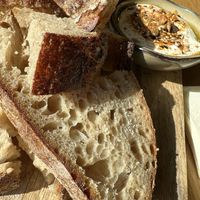 Zuurdesembrood van Meneer Leffers met citroen-knoflooklabneh en dukkah    at Flow Yoga & Food in Delft