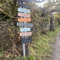 Signpost from the canal by Sparth reservoir  at Wild Cafe in Marsden