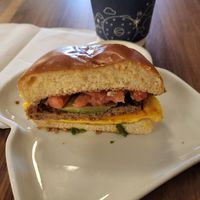 Vegan trifecta with avocado and tomato on vegan brioche bun. at Ayla's Bagel & Coffee in Woodbury