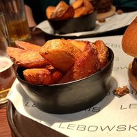 Burger with side of potato wedges at Lebowskis in Glasgow