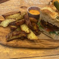 Burger, herby chips and some sort of delicious spicy (sriracha maybe) mayo.   at VIBE Plant Based Cafe & Restaurant in Douglas