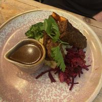 Walnut and butter bean sausages with mash  at VIBE Plant Based Cafe & Restaurant in Douglas