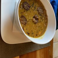 Porotos con riendas y salchicha de la casa  at A Fuego in Copiapo