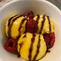 Mango sorbet with raspberries and a pomegranate balsamic reduction drizzle at Idlewild Spirits Brewpub and Restaurant in Winter Park