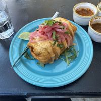 Chimichanga with potatoes, black beans, vegan crema, and pickled onions.   at Black Sheep in Bellingham