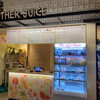 Sign, drink case, wall menu at Mother Juice - High St Place in Boston