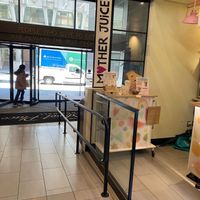 Side entrance, sign, and menu/napkin/cutlery station.  at Mother Juice - High St Place in Boston