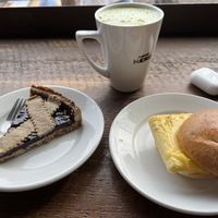 Almond milk match, vegan elderberry tart, vegan breakfast sandwich. Ordered “for here” and got ceramic mug/plates so less waste is awesome, too!  at Caffè Nero - Porter Square in Cambridge