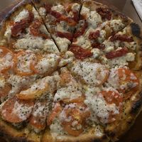 Half primavera caribeña and half sun dried Cozumel   at Coral Vegan Pizza in Playa Del Carmen