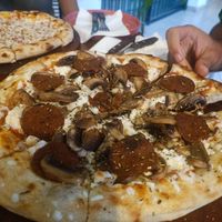 Pizza with pepperoni and mushrooms at Coral Vegan Pizza in Playa Del Carmen