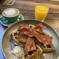 Chickn facon maple syrup waffles, fresh orange juice and a flat white with soya  at Malila Coffee in Valencia