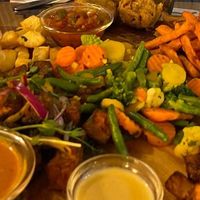 Our delicious vegan platter with tofu, cassava, sweet potato fries, plantain, beignet, beans, veggies and a selection of sauces at Chez Ani in Strasbourg