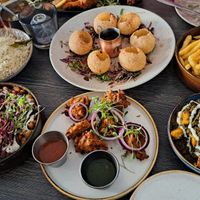 Top L-R - Jeera Rice, Golgappa, Chips. Bottom L-R - Samosa chaat (amazing), vegetable pakora, my friend’s vegetable curry (not vegan)  at Murphy's Pakora Bar in Glasgow