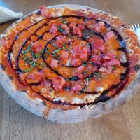 Vegan cheese pizza with diced tomatoes, fresh basil, and a drizzle of balsamic reduction. Crust is perfectly charred from a wood fire oven. 🔥 at Mister O1 in Melbourne