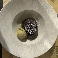 Chocolate cake with liquid center and pistacchio icecream  at Singola Ristorante Naturale in Modica