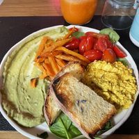 Scrambled tofu with guacamole, sweet potato fries, cherry tomatoes, baby spinach, and toasted bread.  at Zero - Healthy Bar & Poke in Salerno