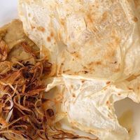 Vegan) Palata (Flat bread) with steamed yellow pea paste topped with caramelized onion. Most famous among Burmese. at Burmese Bites - Food Stall in Queens