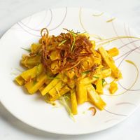 Tofu Salad: Burmese Tofu (made with chickpeas) with roasted bean powder, shredded cabbages mix, homemade tamarind sauce, caramelized onion with thinly shredded kieffer lime leaf  at Burmese Bites - Food Stall in Queens