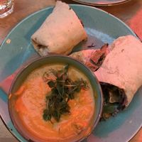 Smoked carrot soup and tofu, chilli and ginger slaw wrap  at Saramago Cafe Bar in Glasgow