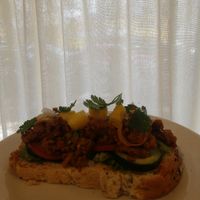 Una tapa de pan integral con pastor vegano at Vegandru in Mexico City