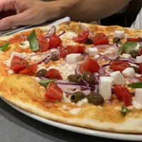 Pizza Greca Vegana with rice mozzarella, olives & cherry tomatoes  at Pizzeria Daniela in Montebelluna