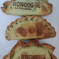 Three vegan empanadas with their names stamped on at La Paisanita in Prague