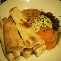 Mediterranean Flat Bread platter: warm Indian flatbread with housemade hummus, muhammara, carrot terche, and kalamata olives. at Dobhan in Madison
