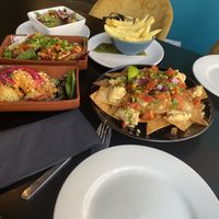3 sharing plates and sides of salad and seasoned chips   at Jungle Bird in Birmingham