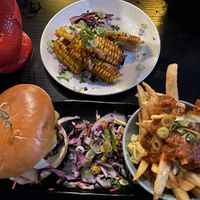 jungle is massive burger with jerk fries and corn to be wild side dish  at Jungle Bird in Birmingham