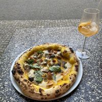 Kirby pizza- with pumpkin crème, Al’s mozzarella, vegan sausage and roasted eggplant.   at Al Catzone Pizza Napovegana in Berlin