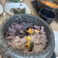 Purple rice topped with ginko and pumpkin in a hot stone pot  at Ilpum Soft Tofu  in Jeju