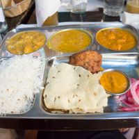 Thali – which is a huge indian plate consisting of different curries and additional portions of rice, pakora, papadam (the thin bread) and pickled onions at Veggie Garden - Dels Angels in Barcelona