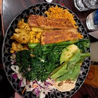 Spicy rice bowl with plant based stiks and avokado at Nando's in London