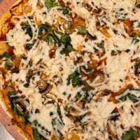 pizza with cashew cheese, marinara, & veggies at Arizmendi Bakery and Pizzeria in Emeryville