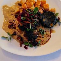 Cauliflower steak with tahini sauce, pecans, & sweet potato puffs. Photo does not do it justice! at The Reluctant Panther in Manchester
