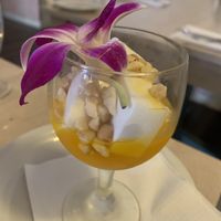 Coconut pudding with mango syrup   at Kau Kau in Sacramento