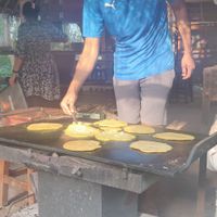 Cooking some delicious vegan banana pancakes! at Sadhana Forest Seva Kitchen in Auroville