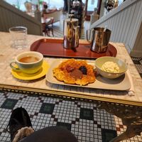 Waffle with vegan cream, jam, and chocolate frosting, and a french press coffee with oat milk at Valkyrjan Bistro & Bar in Reykjavik