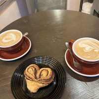 Plant-based cappuccino and café latte with a vegan cinnamon rolll  at OA Coffeeshop in Tallinn