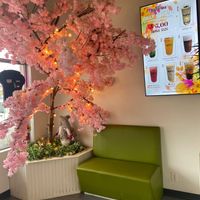 Cute little selfie spot next to the $5 drink special for each day.  at Oishii Tea in Brampton